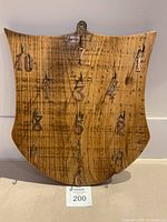 Front view showing full shield shape, ten hooks and copper numerals