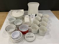 All items laid out: cups, casseroles, butter dish, ramekins, bowls, Les Saisons plate, tray