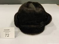 Front view of fur winter hat showing ear flaps folded up