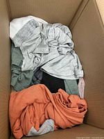 Overview of box showing assorted folded women’s garments