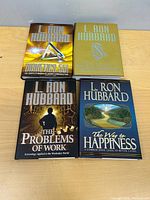 Four L. Ron Hubbard hardcover books on tabletop