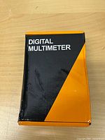 Closed box labeled DIGITAL MULTIMETER