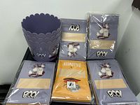 Lot overview showing one purple bucket and five sealed packs of Halloween treat bags