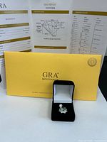 Pendant, box and yellow GRA sleeve