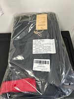 Sealed RAISMORE car seat travel bag in plastic with large suffocation warning label