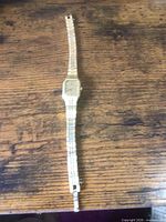 Full view of watch laid flat showing case and entire bracelet