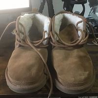 Front view of both boots showing suede uppers and laces