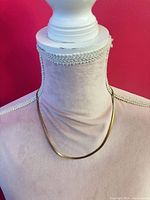 Necklace displayed on bust form showing overall appearance and lay