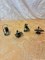 All four mixed-metal figurines on display