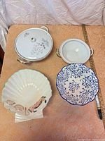 Group shot of all four porcelain and ceramic pieces with yardstick for scale