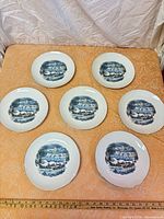 Full set of seven winter scene plates displayed face up