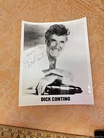 Full view of signed photograph with ruler for scale