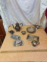 Overall view of the nine silver-plated pieces on table