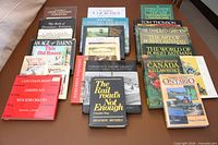 All 24 books laid out on table showing covers and spines