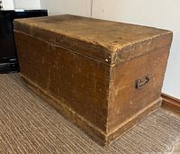 Full view of pine trunk chest showing overall form and finish