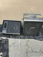 Front view of both speaker cabinets showing grille, horn and overall wear