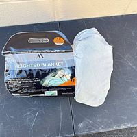 Packaged Amélie Home weighted blanket with part of blanket visible