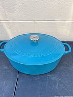 Closed Dutch oven showing exterior color and Cuisinart branding on lid