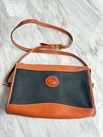 Front view of pouch showing leather body, trim and overall condition