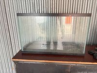 Front view of rectangular glass aquarium with black trim