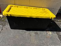 Full view of black tote with yellow lid