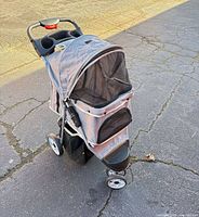 Front three-quarter view showing overall stroller, fabric color, mesh panels, wheel configuration