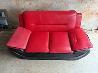 Front view of red and black faux leather loveseat