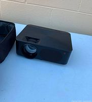 Front view of ONN projector showing lens and speaker grille