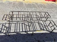 Top view of both folding metal bed frames set up side by side