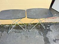Pair of folding tables side by side showing overall design and legs