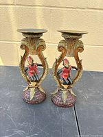 Front view of both matching resin monkey candle holders