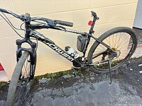 Full view of black Schwinn 29" mountain bike leaning on wall