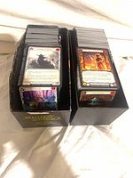 Two storage boxes filled with Flesh and Blood trading cards