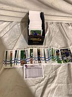 Open Topps storage box filled with baseball cards; several cards fanned in front