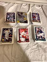 Six stacks of 2025 Topps base cards showing various players
