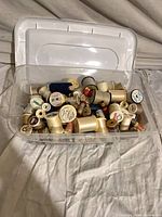plastic box with assorted thread spools