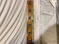 Vanity light strip faceplate with six sockets viewed top, alongside carton