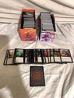 Two deck boxes filled with cards; row of loose Flesh and Blood cards displayed face up