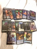 Spread of multiple foil MTG tokens in sleeves