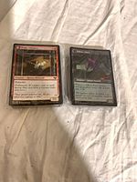 Front view of two sleeved sample cards (Voldaren Estate, Odious Witch) showing foil sheen