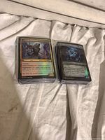 Two stacks of Magic: The Gathering foil cards