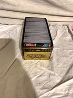 Cards neatly stacked in gold Yu-Gi-Oh! tin