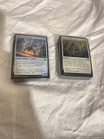Two wrapped stacks of Magic: The Gathering cards
