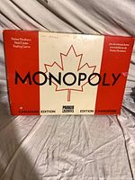 Top view of Monopoly Canadian Edition box showing title and maple leaf graphic