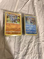 Two stacks of sleeved Pokémon cards, front card Machamp holo