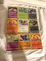 Nine loose Pokémon cards laid out
