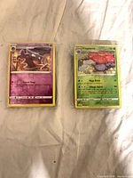 Two wrapped stacks showing Haunter and Vileplume reverse holo cards on top