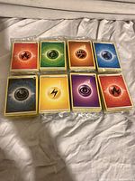 Front view of eight sealed Energy card stacks showing symbols