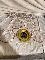 All items laid out: 4 cups, 4 saucers, 1 metal plate