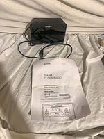 Front view of Sony ICF-C414 clock radio with manual and AC cord